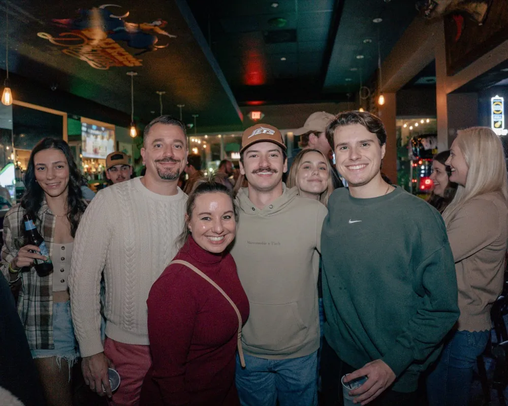 A group of regulars gathered at a busy bar
