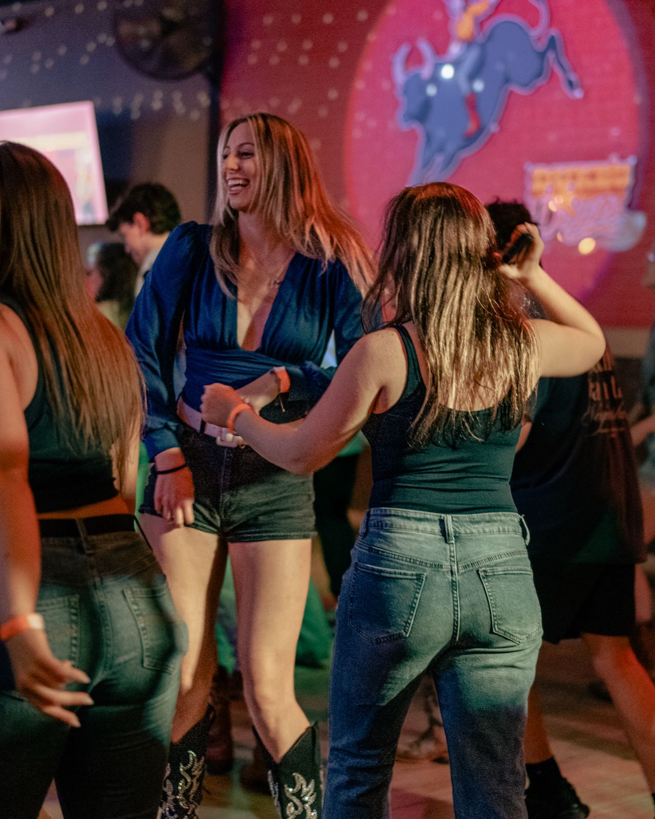 Guests dancing together at a lively Denver bar