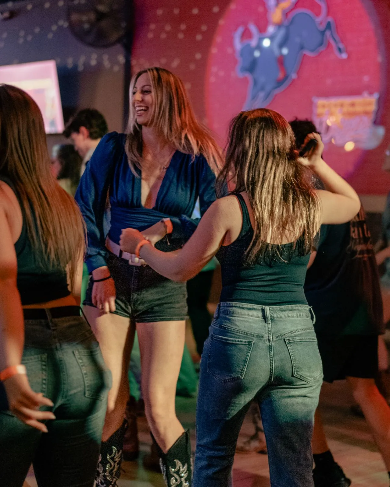 Guests dancing together at a lively Denver bar