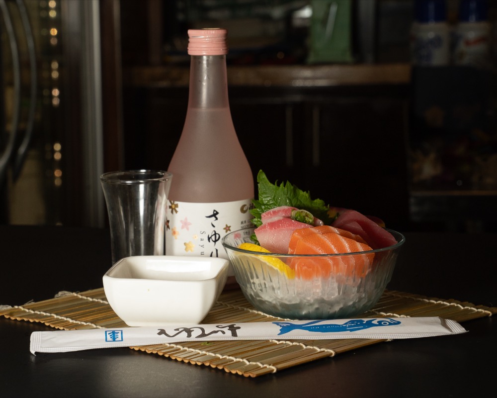 A sake pour at a Denver restaurant table during service